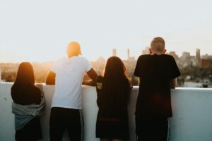 four person looking at the city. Christian business leader fostering integrity and values-driven relationships in a supportive workplace environment