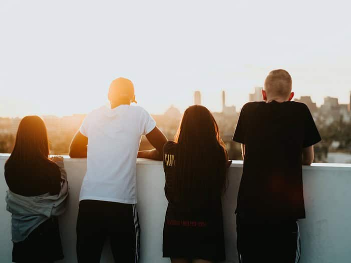 four person looking at the city. Christian business leader fostering integrity and values-driven relationships in a supportive workplace environment