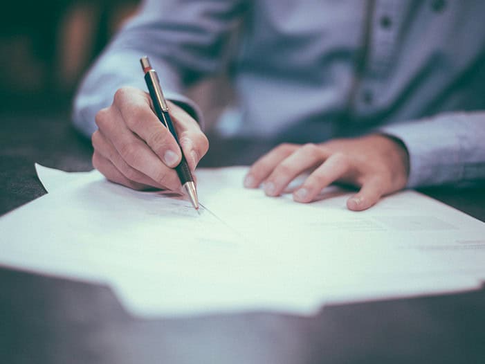 man writing on paper. Christian business leader engaging with team in a collaborative, faith-centered workplace environment, focused on integrity and purpose