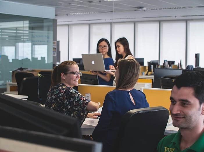 people inside room, Christian business leader fostering a workplace culture of love, grace, and mercy, with employees connecting in a warm and supportive environment